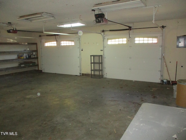 garage featuring electric panel and a garage door opener