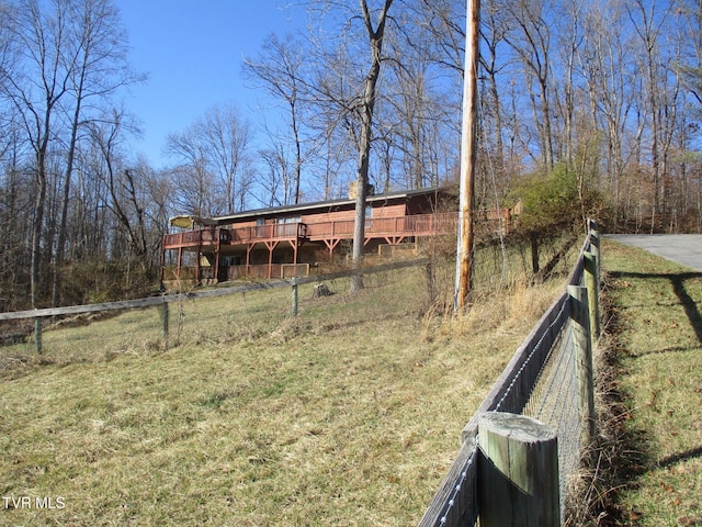 view of yard featuring fence and a deck