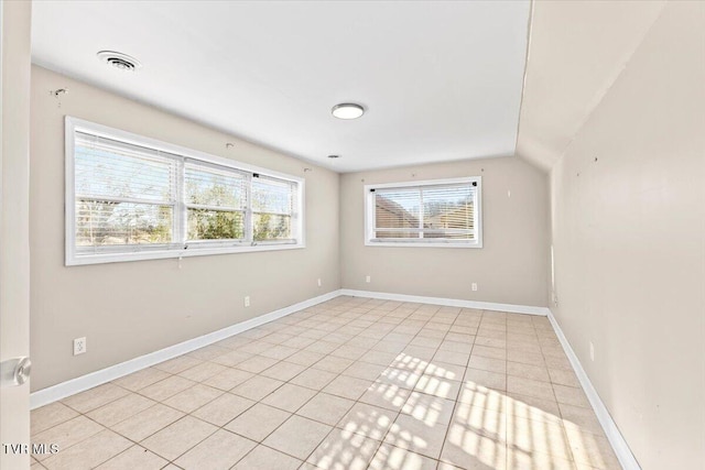 spare room featuring visible vents, baseboards, and light tile patterned flooring