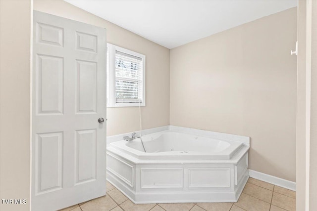 full bathroom featuring tile patterned floors, baseboards, and a bath