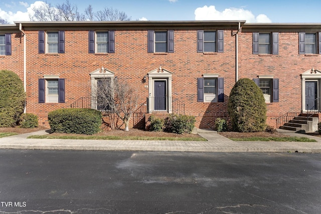 townhome / multi-family property with brick siding