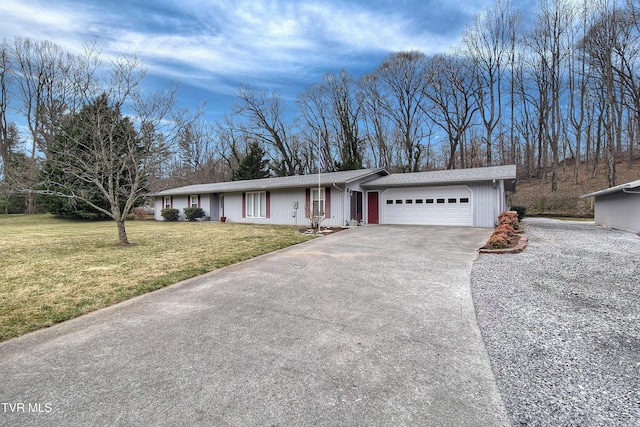 ranch-style house featuring a front lawn, an attached garage, and concrete driveway