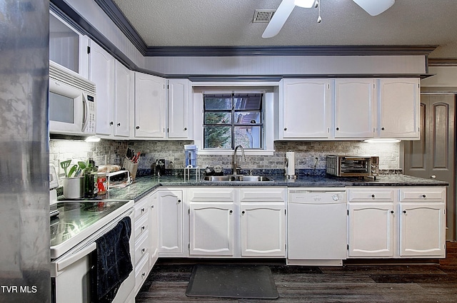 kitchen with a sink, white appliances, ornamental molding, and white cabinets