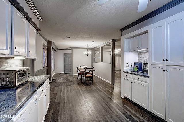 kitchen with dark countertops, tasteful backsplash, dark wood-style flooring, and ornamental molding