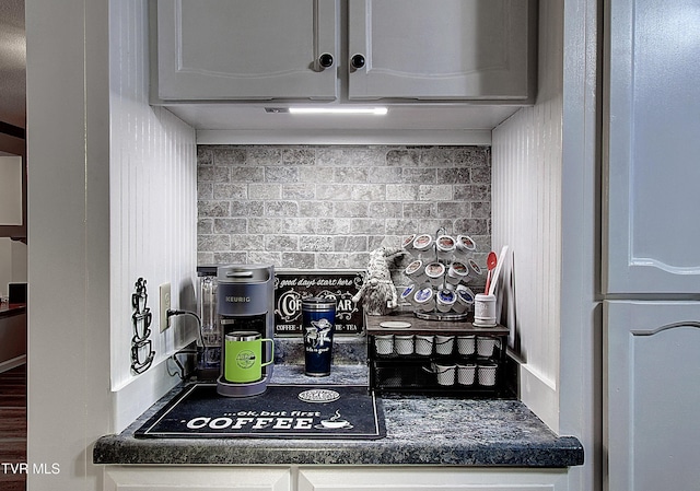 kitchen with dark countertops and under cabinet range hood