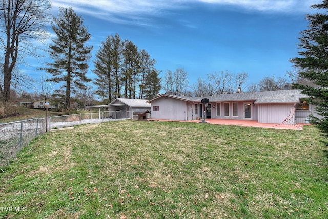 back of property featuring a patio, a lawn, and fence