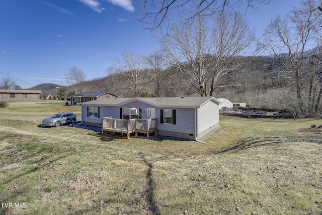 view of front facade with crawl space, a deck, and a front lawn