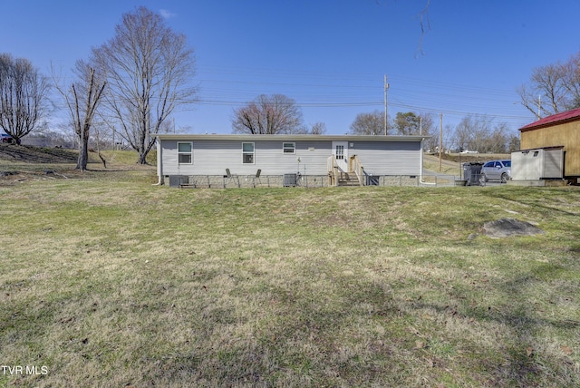 back of property featuring entry steps, crawl space, and a yard