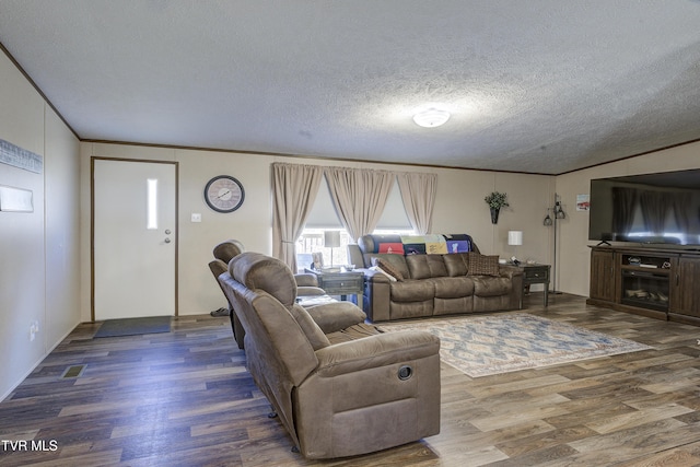 living area with crown molding, a textured ceiling, and wood finished floors