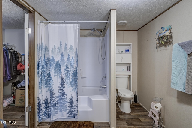 bathroom featuring a textured ceiling, shower / bath combo, wood finished floors, and toilet