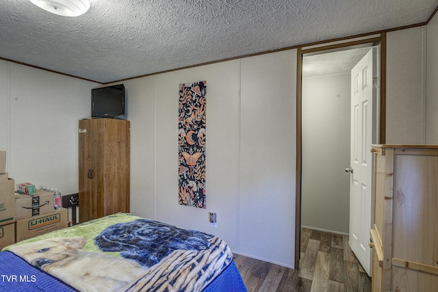 bedroom featuring a textured ceiling and wood finished floors