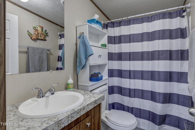 bathroom featuring a textured ceiling, ornamental molding, and vanity