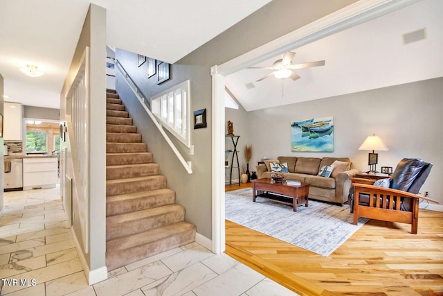 living room with lofted ceiling, visible vents, baseboards, stairs, and marble finish floor