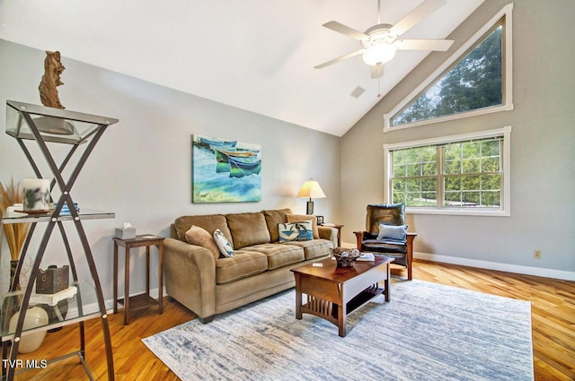 living room featuring visible vents, baseboards, a ceiling fan, wood finished floors, and high vaulted ceiling