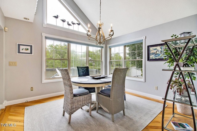 dining area featuring plenty of natural light, baseboards, and an inviting chandelier