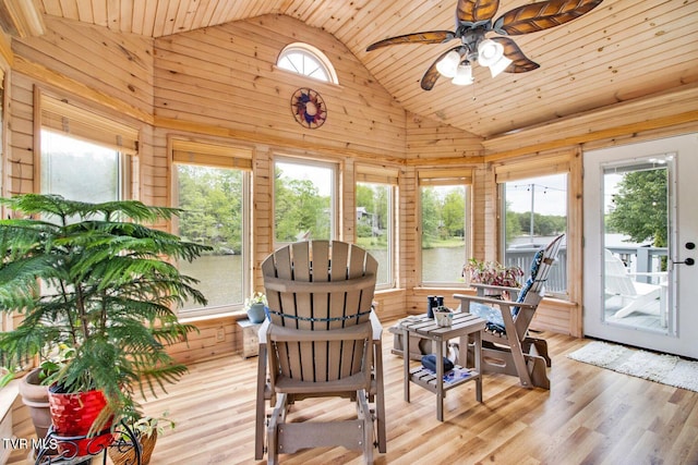 sunroom / solarium featuring lofted ceiling, wooden ceiling, and a ceiling fan