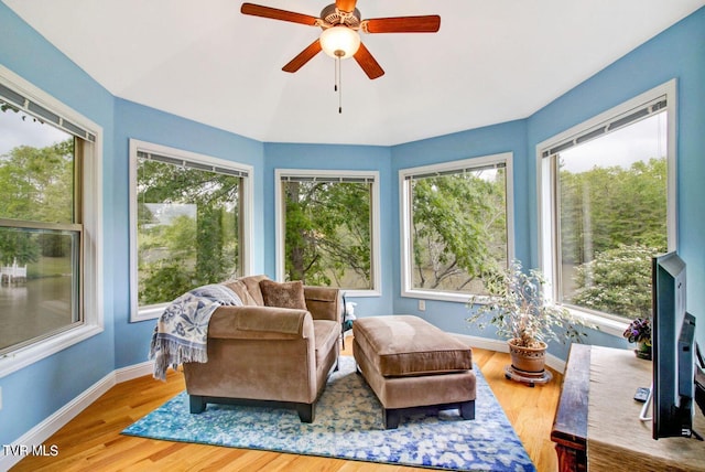 sunroom featuring a ceiling fan