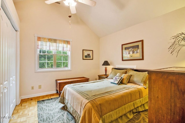 bedroom featuring a closet, baseboards, vaulted ceiling, and a ceiling fan