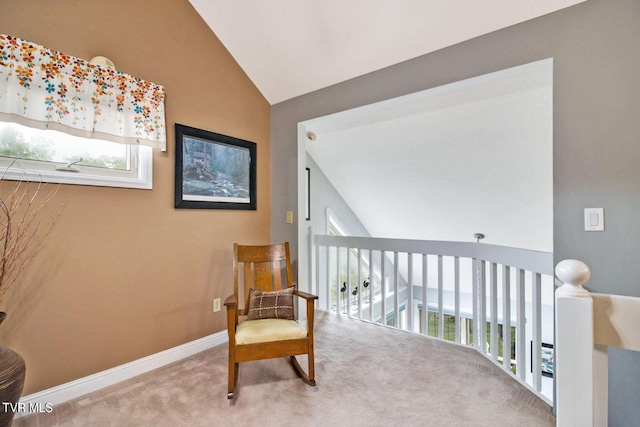 sitting room with lofted ceiling, carpet flooring, plenty of natural light, and baseboards