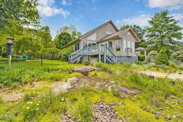 back of property featuring stairs, fence, and a wooden deck