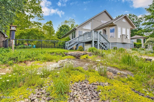 exterior space with fence, stairway, and a deck