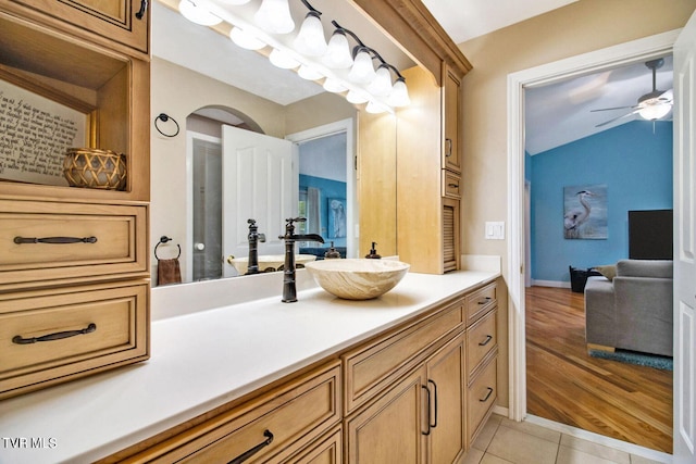 bathroom featuring ceiling fan, vanity, baseboards, and tile patterned floors