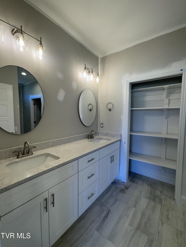 bathroom with double vanity and a sink