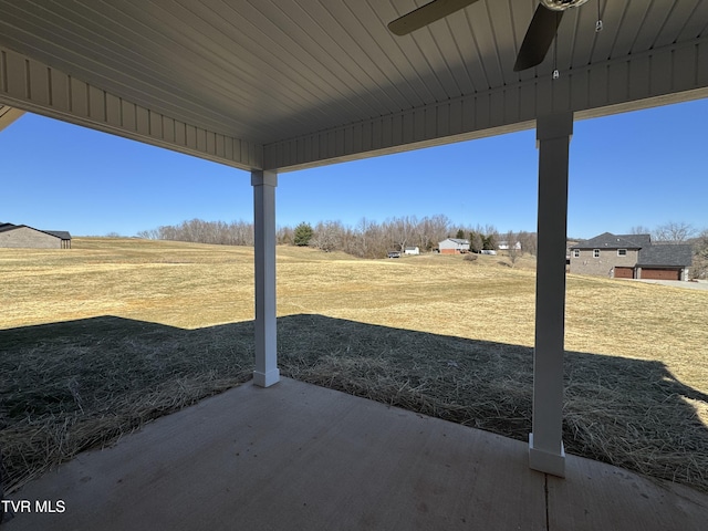 view of yard with a patio area and a ceiling fan