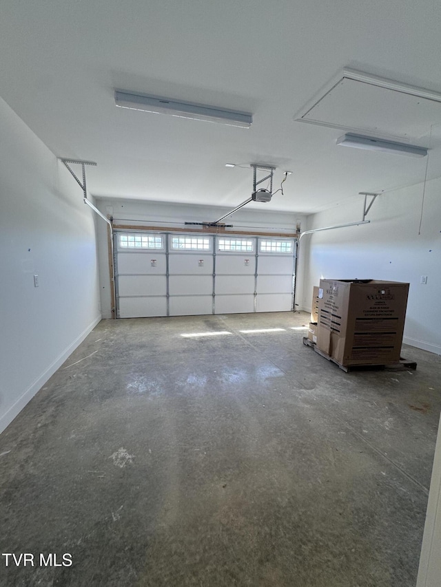 garage with a garage door opener and baseboards