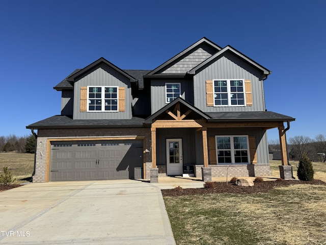 view of front of property featuring a garage, driveway, brick siding, and board and batten siding