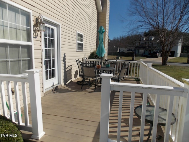 wooden terrace with outdoor dining area