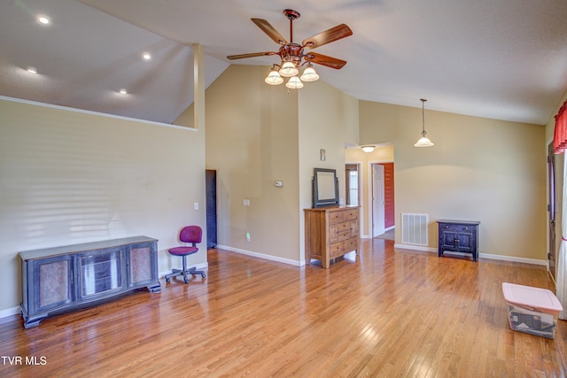 living area featuring high vaulted ceiling, a ceiling fan, visible vents, baseboards, and light wood finished floors