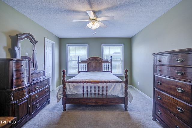 bedroom with light carpet, ceiling fan, a textured ceiling, and baseboards