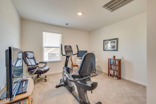 workout room featuring baseboards, visible vents, and light colored carpet