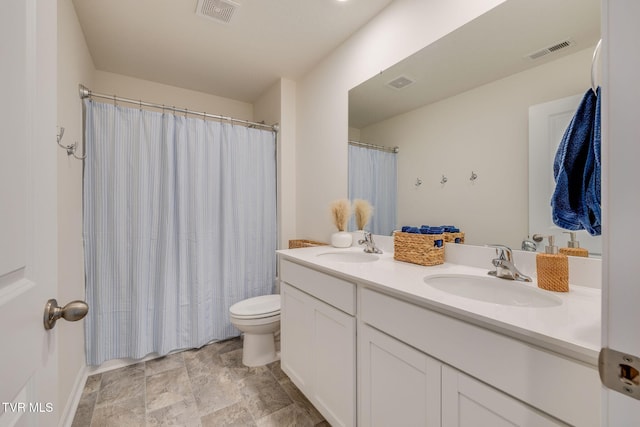 full bath featuring visible vents, a sink, and double vanity