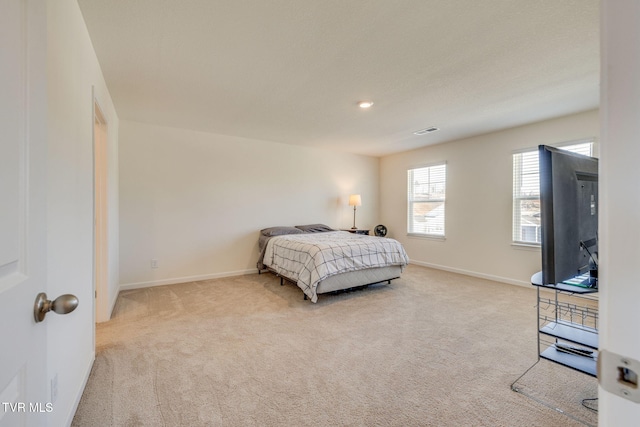 bedroom with light carpet, baseboards, and visible vents