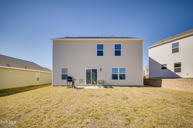 rear view of house with a patio and a lawn