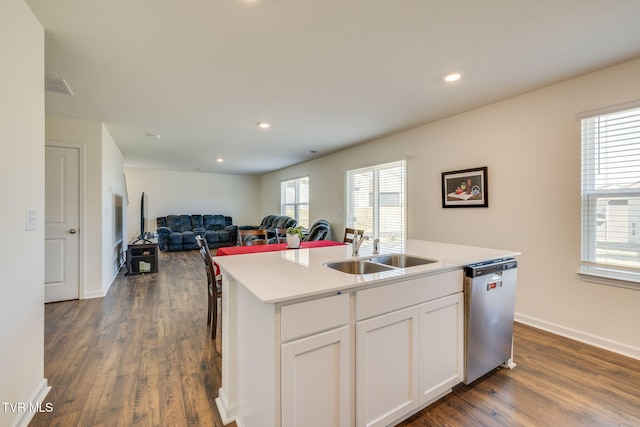 kitchen featuring a center island with sink, open floor plan, white cabinetry, a sink, and dishwasher