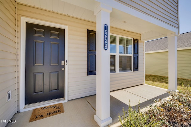 view of exterior entry with a porch