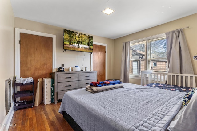 bedroom with dark wood finished floors