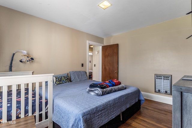 bedroom with baseboards and dark wood finished floors