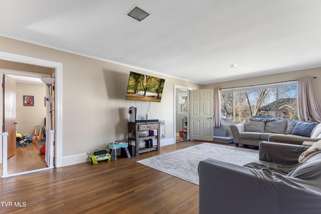 living room with dark wood-style floors, ornamental molding, and baseboards