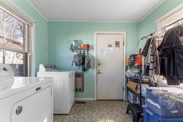 clothes washing area featuring crown molding, laundry area, independent washer and dryer, and heating unit