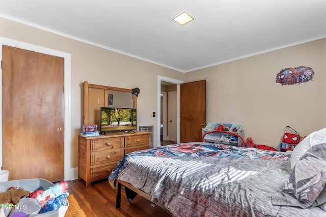 bedroom featuring ornamental molding and wood finished floors