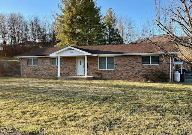 single story home featuring brick siding and a front yard