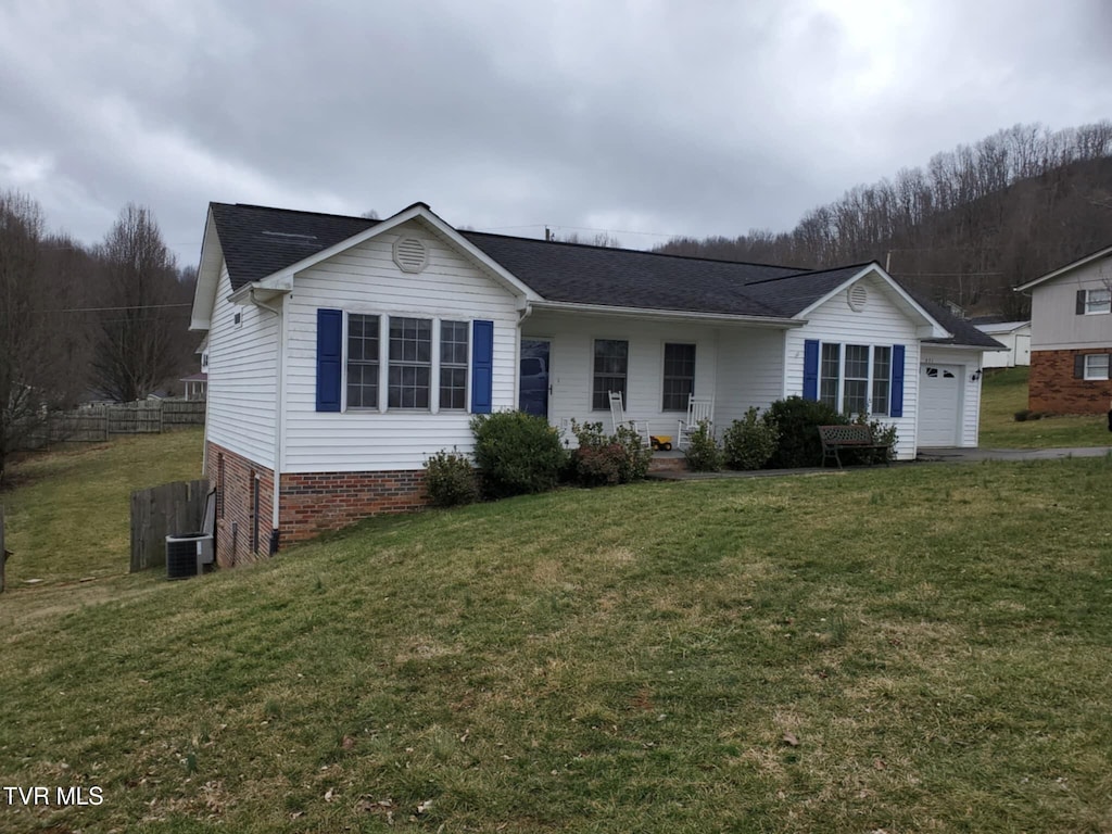 ranch-style home with a garage and a front lawn