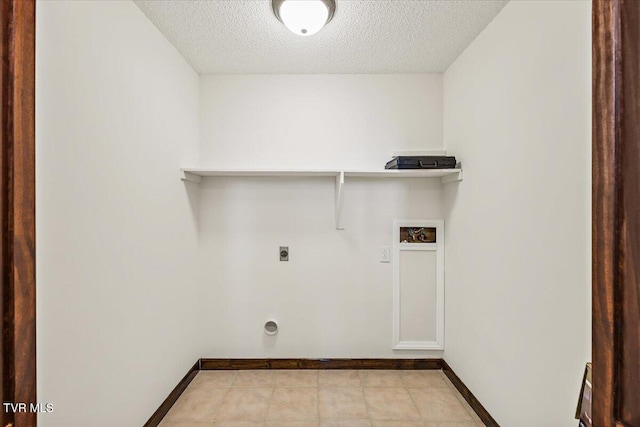 laundry area featuring a textured ceiling, laundry area, washer hookup, baseboards, and electric dryer hookup