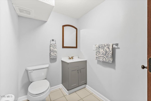 bathroom with baseboards, visible vents, toilet, tile patterned floors, and vanity