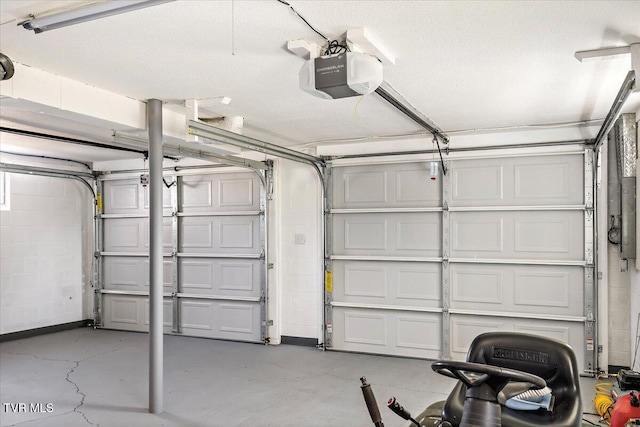 garage featuring concrete block wall and a garage door opener