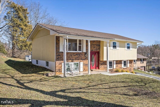 bi-level home with a front lawn and brick siding